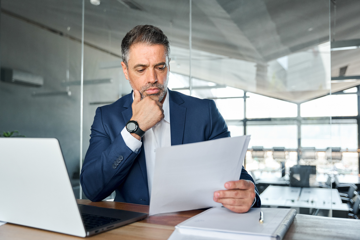 professional business man wearing a suit holding financial documents for tax planning